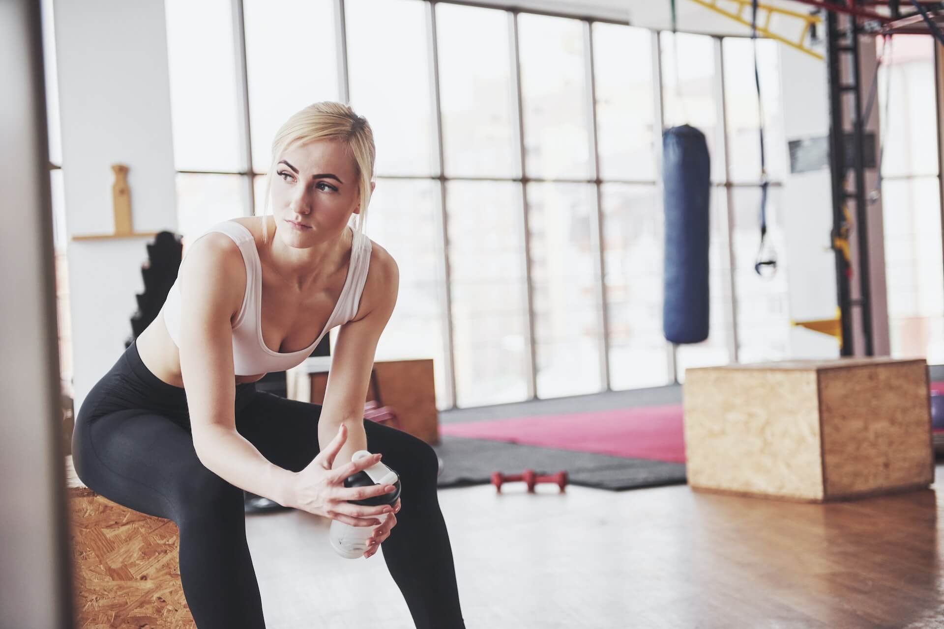 woman holding water bottle at the gym